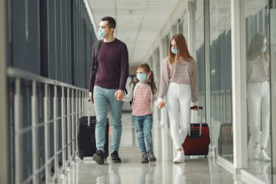 People in airport are wearing masks to protect themselves from virus