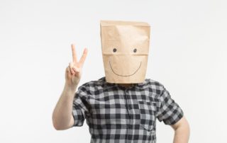 men in paper bag mask hiding identity